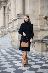 a lady in a black turtleneck dress